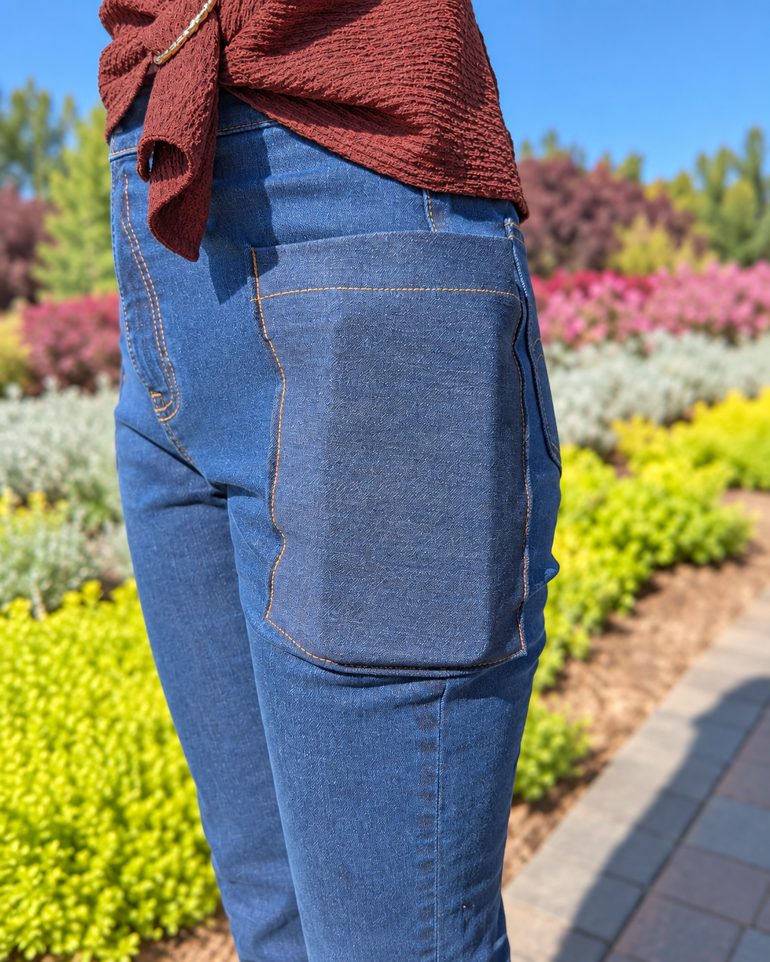 Close-up side view of the large angled thigh pocket on dark-wash Roo’s jeans.