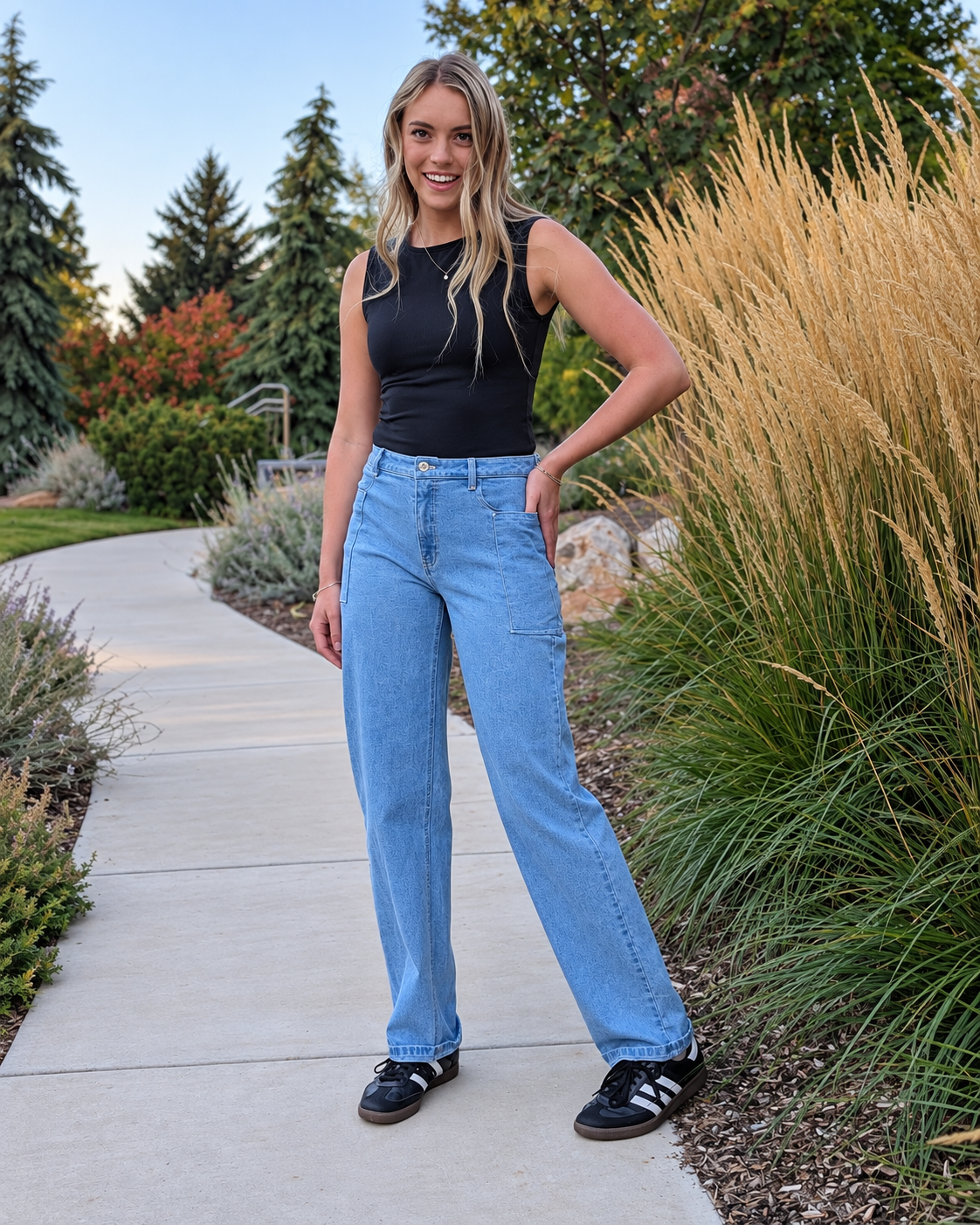 Model standing on a path wearing Roo's light-wash mom jeans